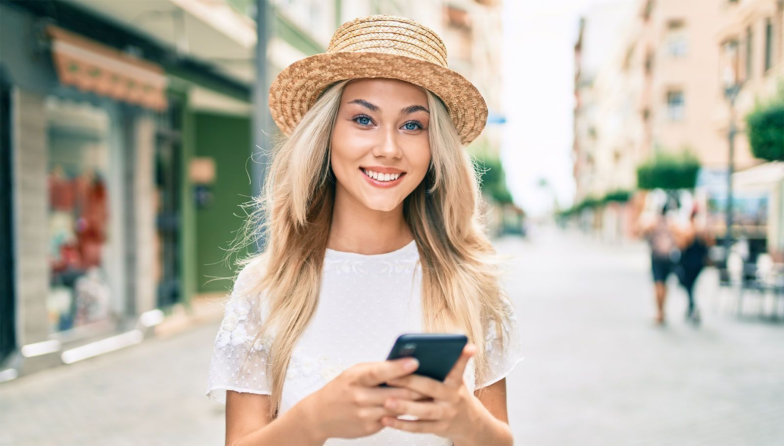 Woman in city holding a smartphone